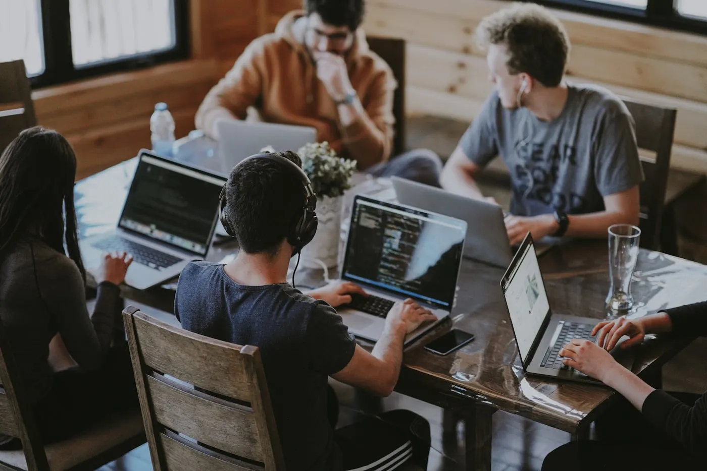 People working together on laptops at a shared table
