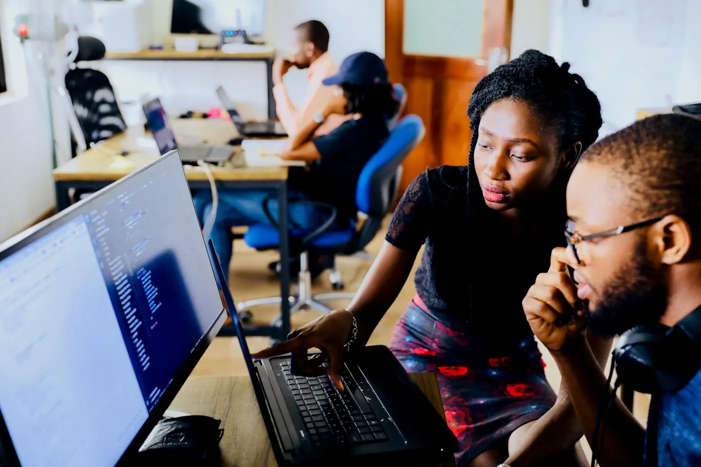 People working at computers in an open-plan office